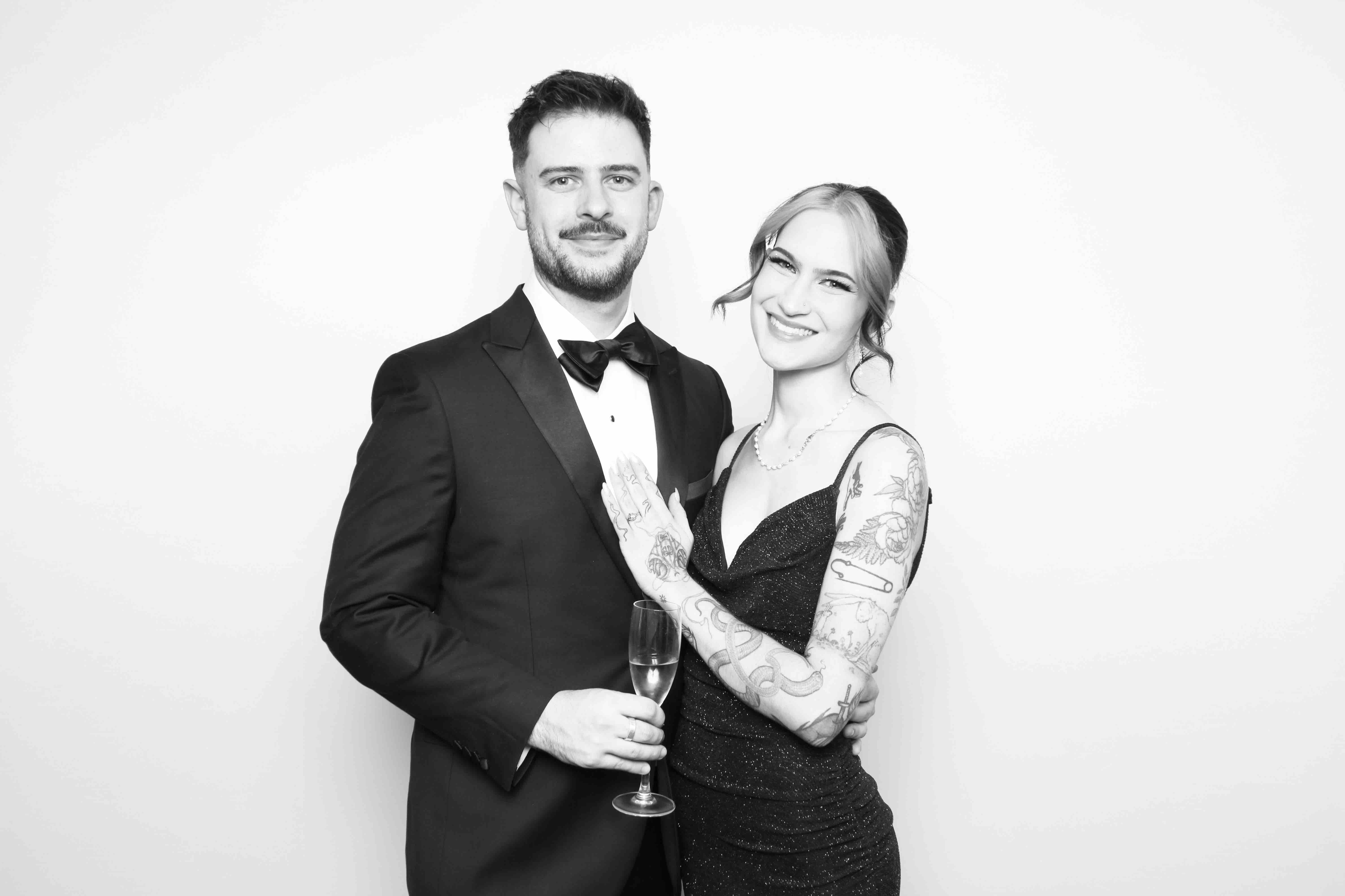 Couple posing in a glam photo booth