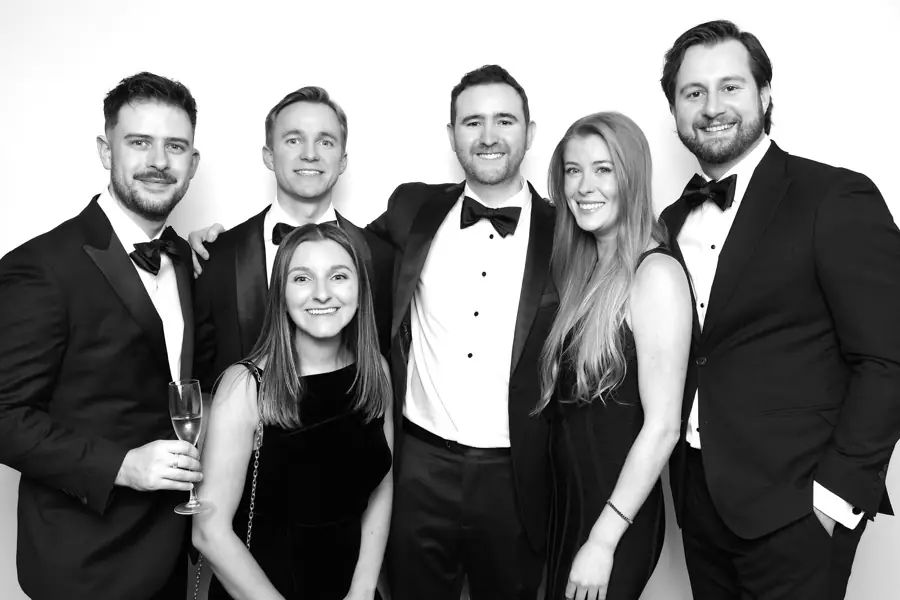 Glam-style black and white photo booth portrait.